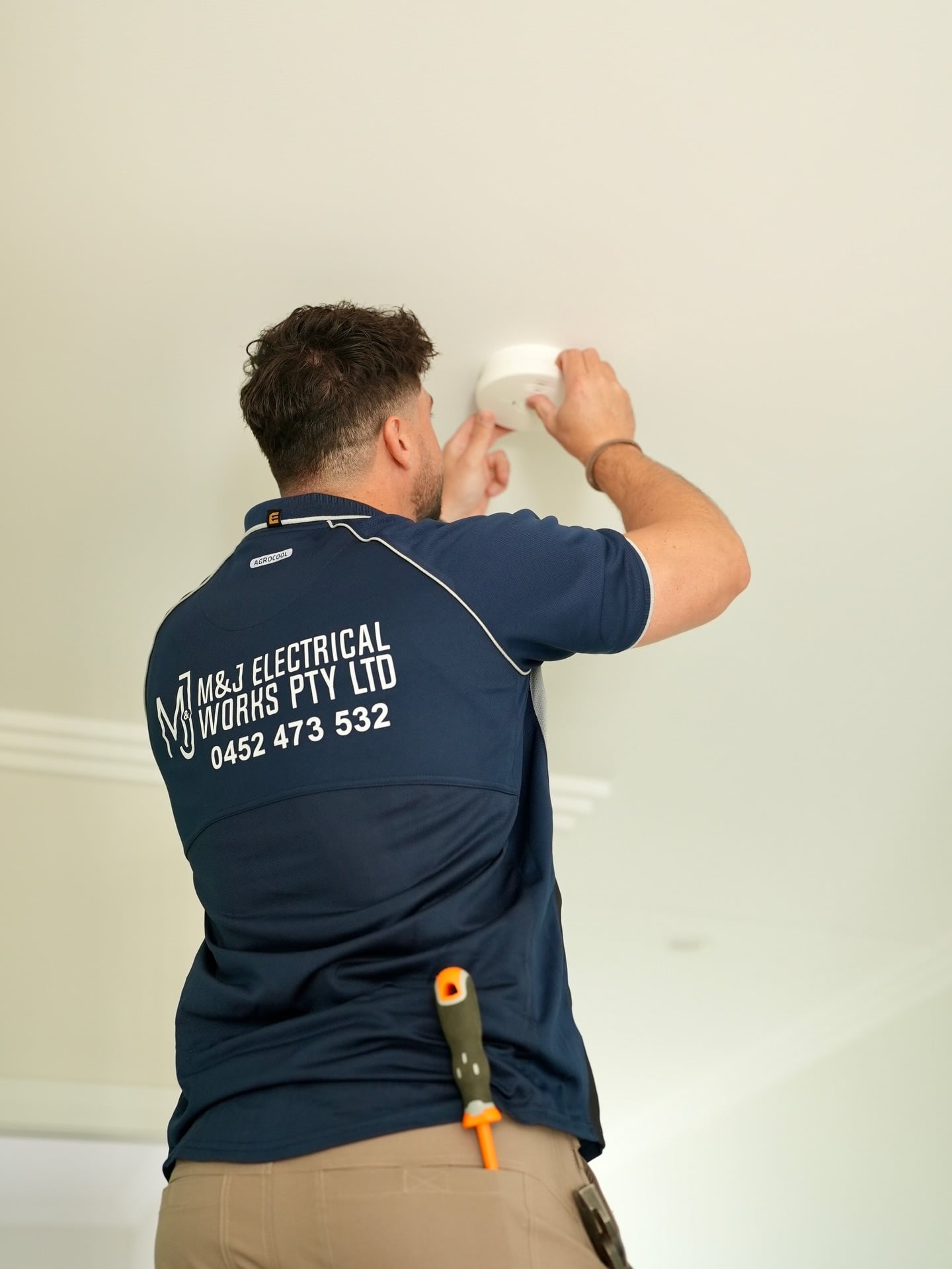 Interconnected photoelectric smoke alarm installed in a hallway ceiling