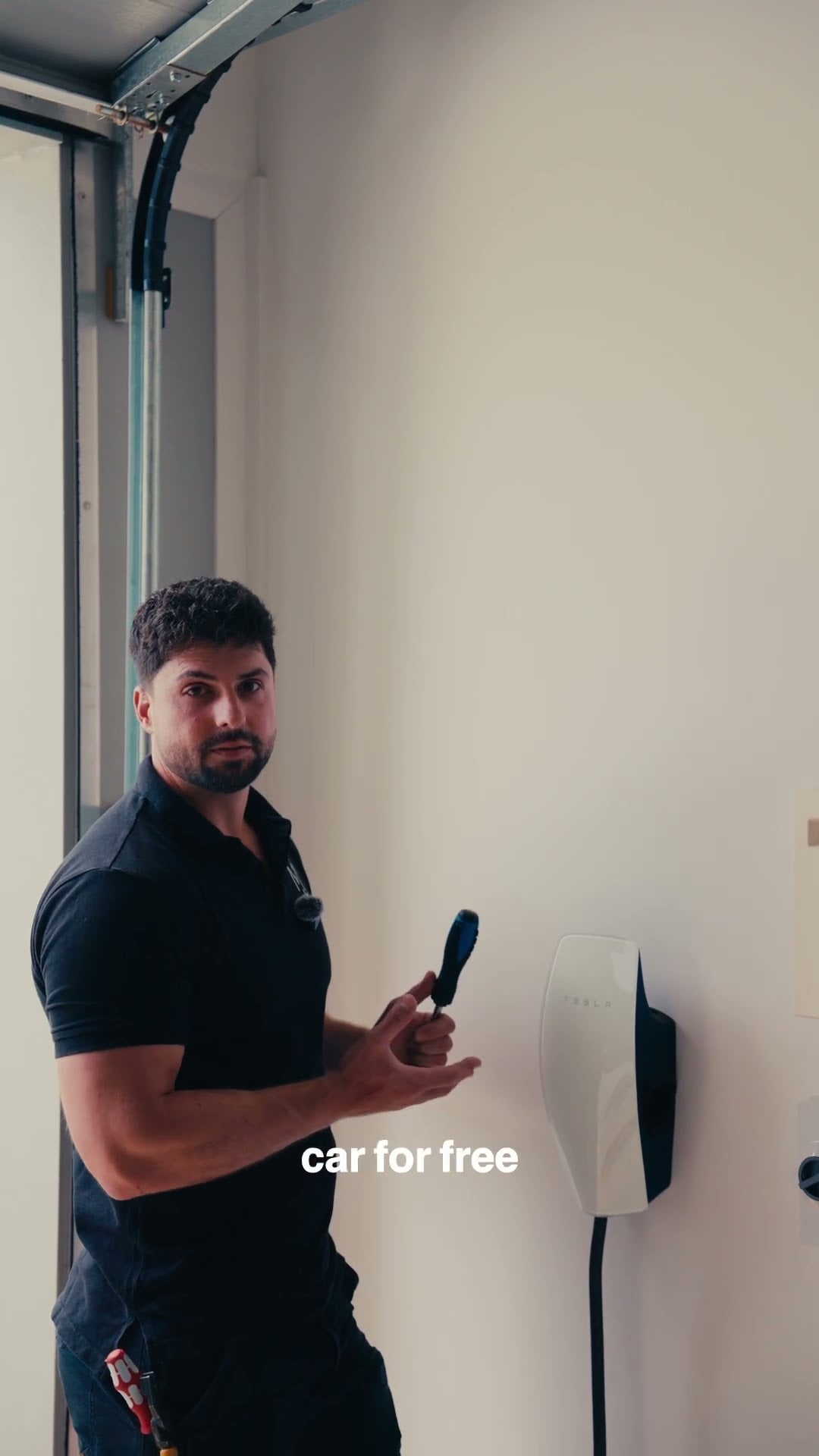 Electrician beside a home EV charger explaining running cost savings