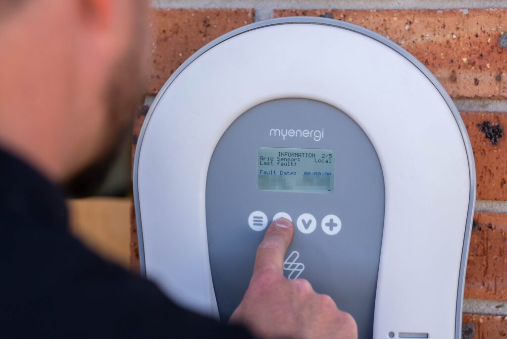 Close-up of a myenergi Zappi EV charger screen being commissioned at a Hoxton Park home