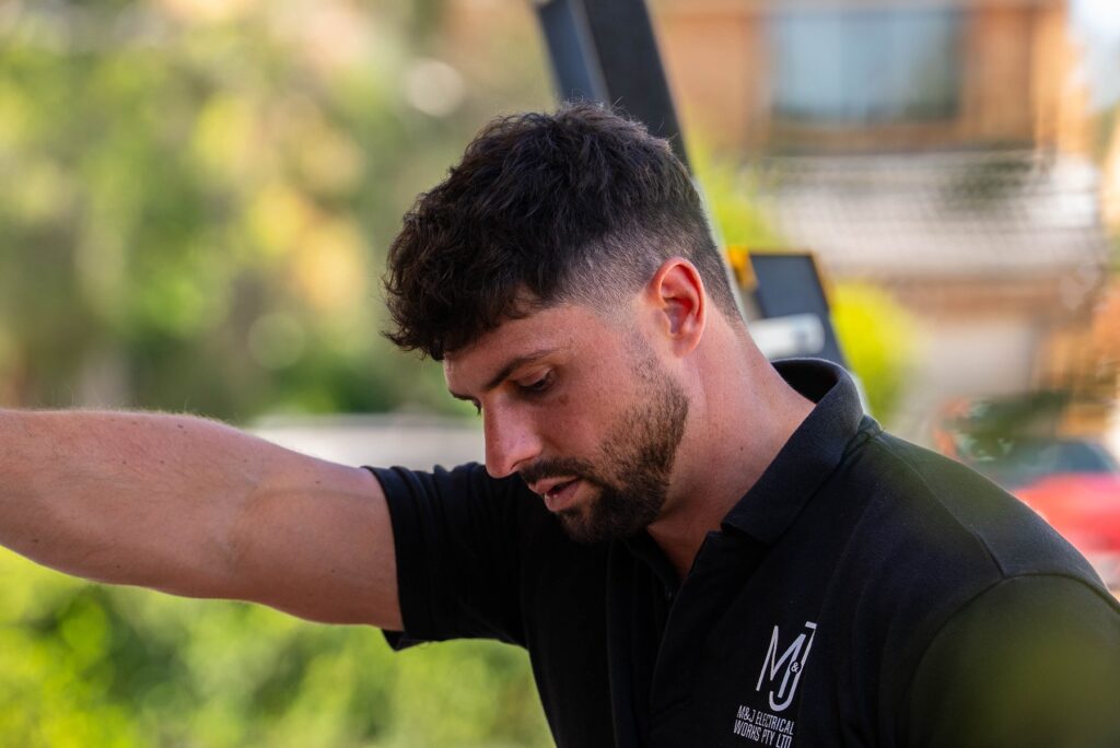 Michael from M&J Electrical Works on site during an EV charger and switchboard job in Hoxton Park